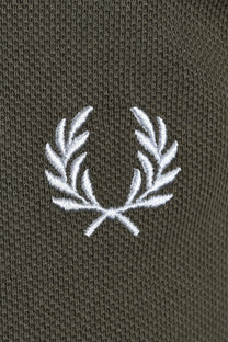 Close-up of a fred perry logo on a green polo