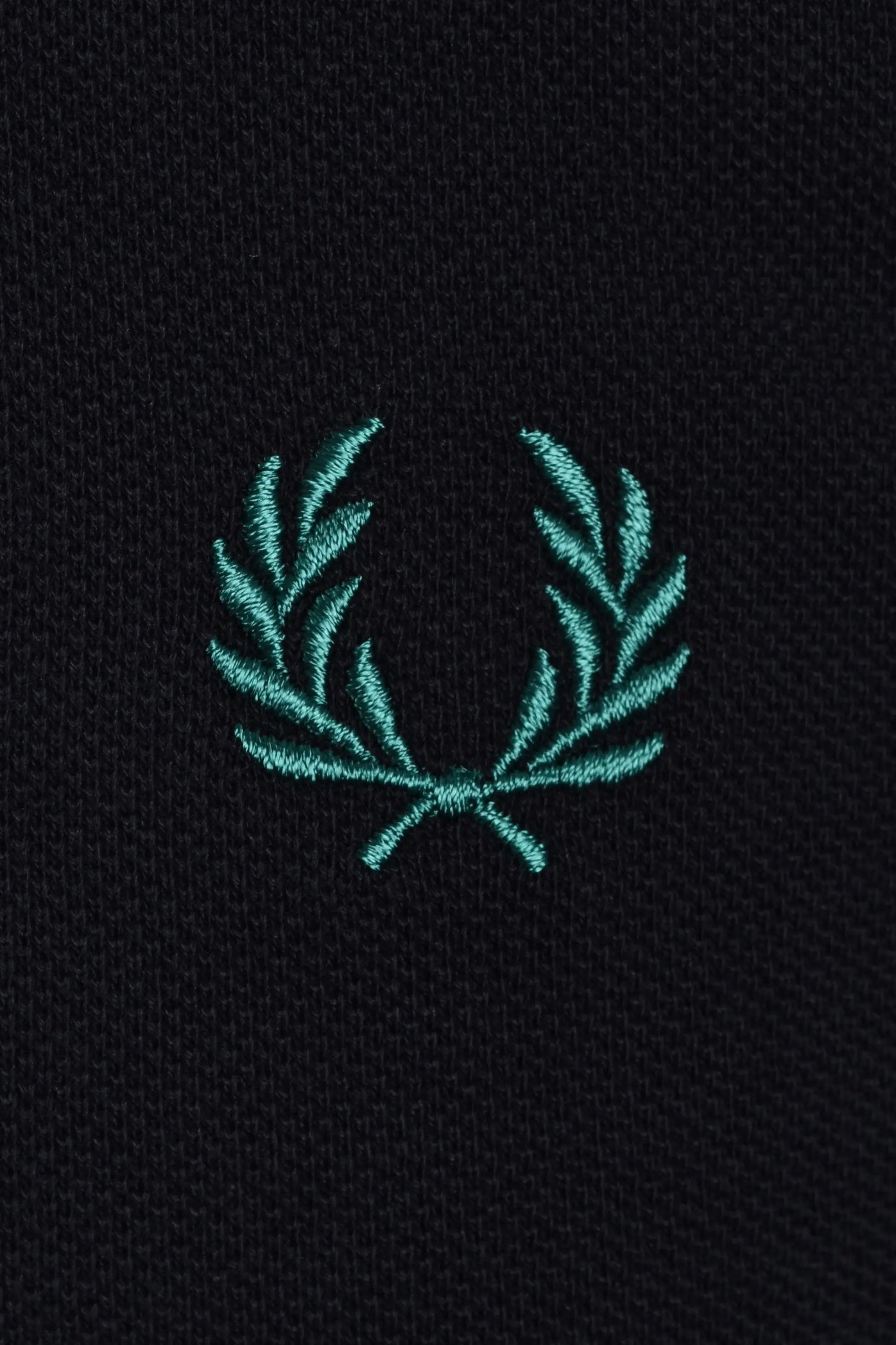 Teal fred perry embroidered logo on a navy polo