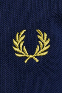 yellow embroidered fred perry logo on a navy blue polo