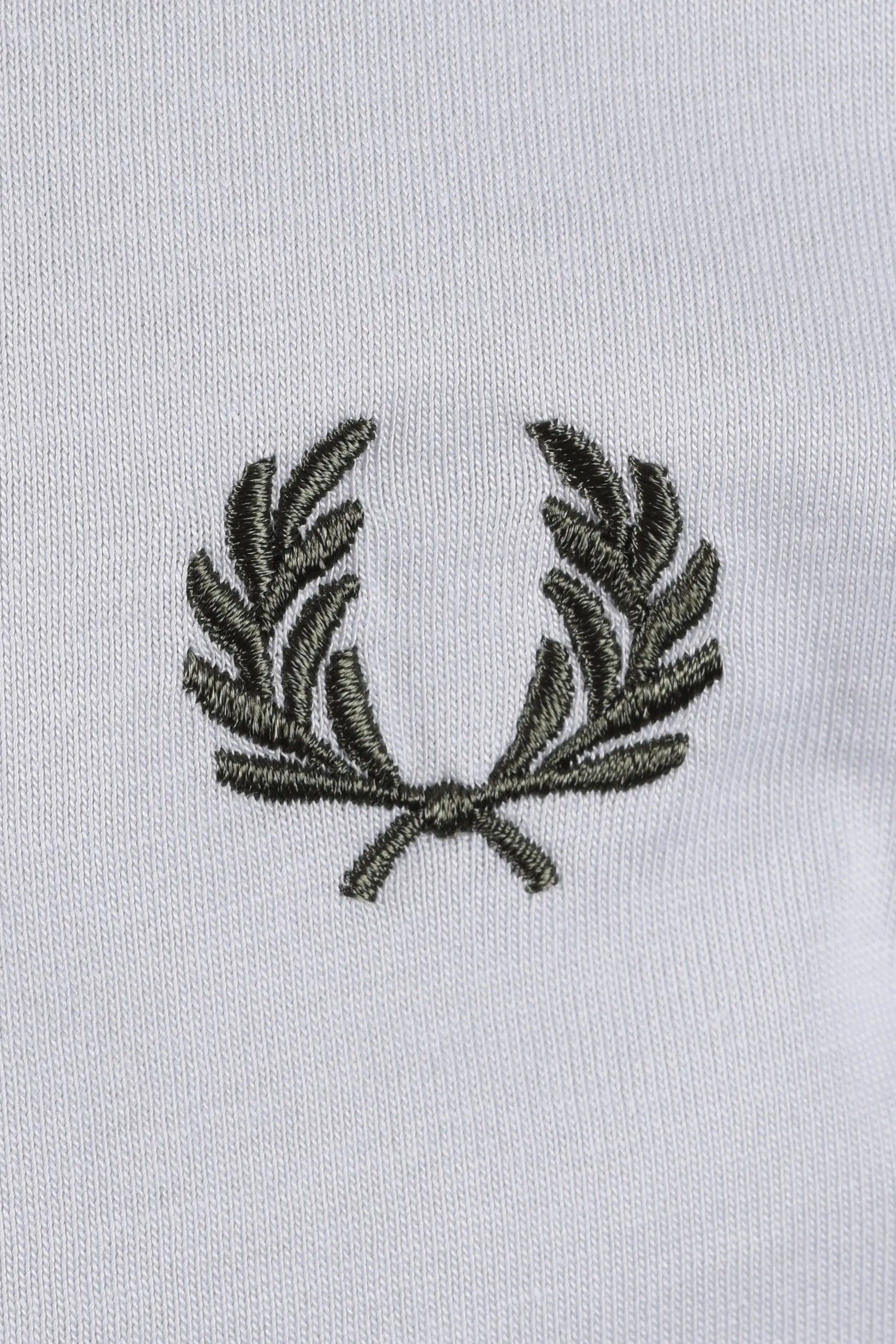Embroidered  green fred perry logo on a light blue t-shirt
