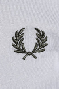 Embroidered  green fred perry logo on a light blue t-shirt