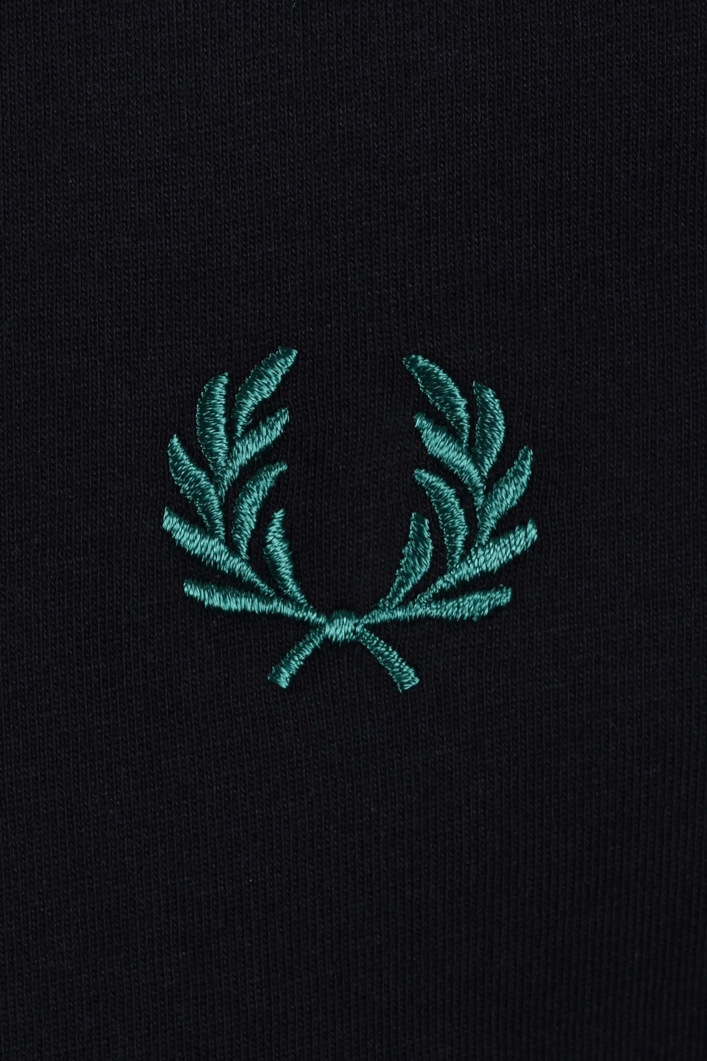 Teal fred perry embroidered logo on a navy t-shirt