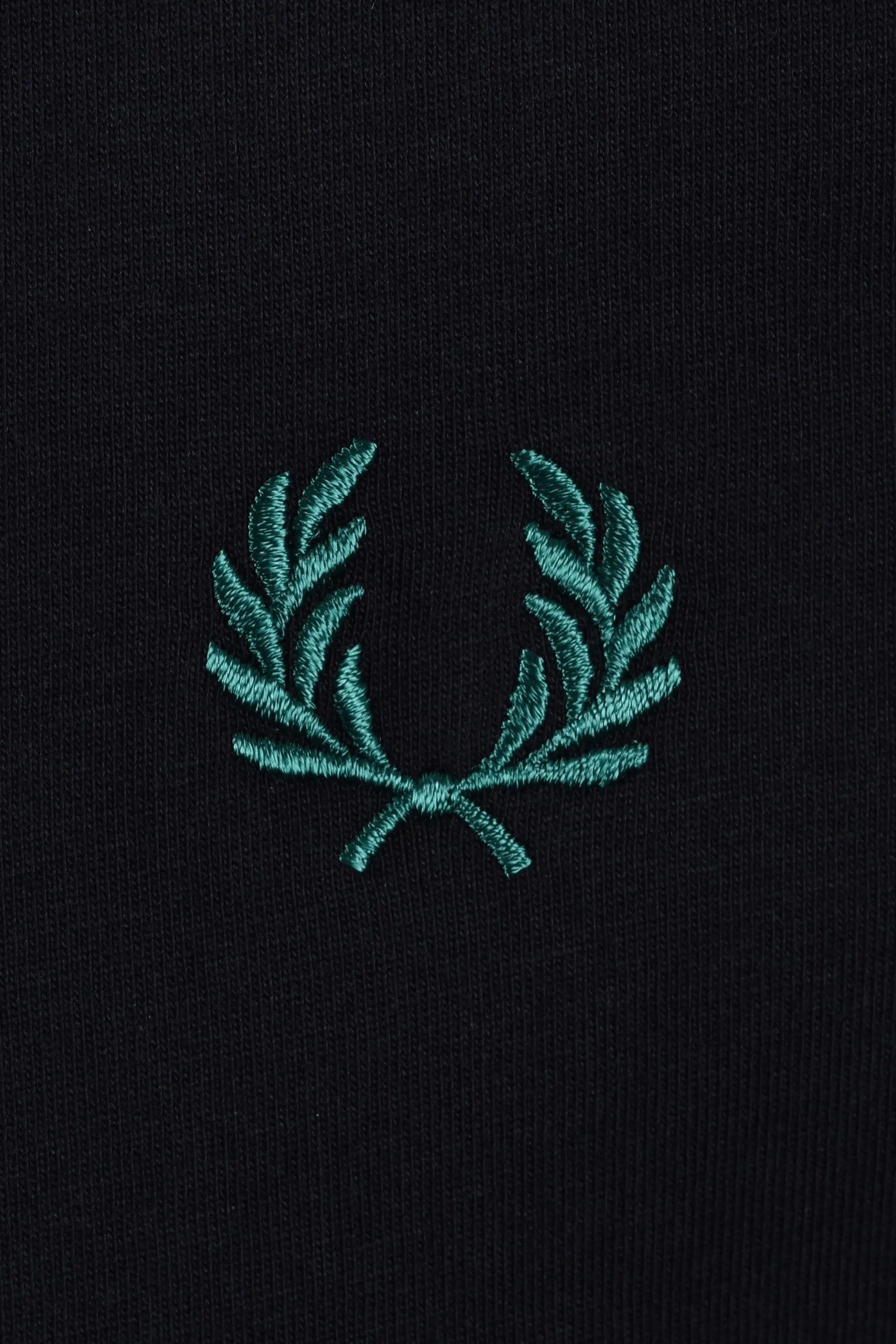 Teal fred perry embroidered logo on a navy t-shirt