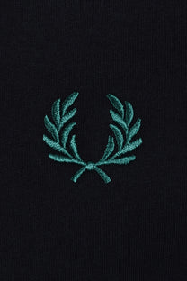 Teal fred perry embroidered logo on a navy t-shirt