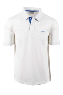 Full image of a Gant contrast pique polo in the colour egg shell. It features a contrasting blue colour throughout the placket and the branding and is pictured  on a white background.