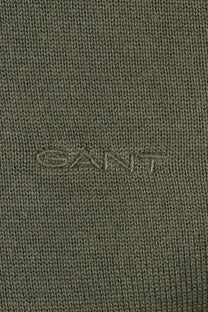 Close up of the embroidered Gant logo on a knitted material all in a dry herb green colour.