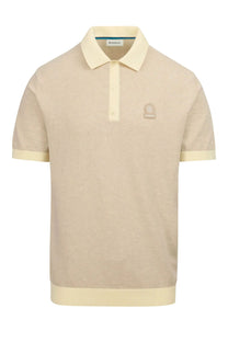 A picture of a Sandbanks knitted polo in beige it has a matching beige coloured Sandbanks logo up on the chest.