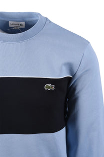 Side image of a Lacoste sweatshirt, featuring the iconic Lacoste crocodile logo.