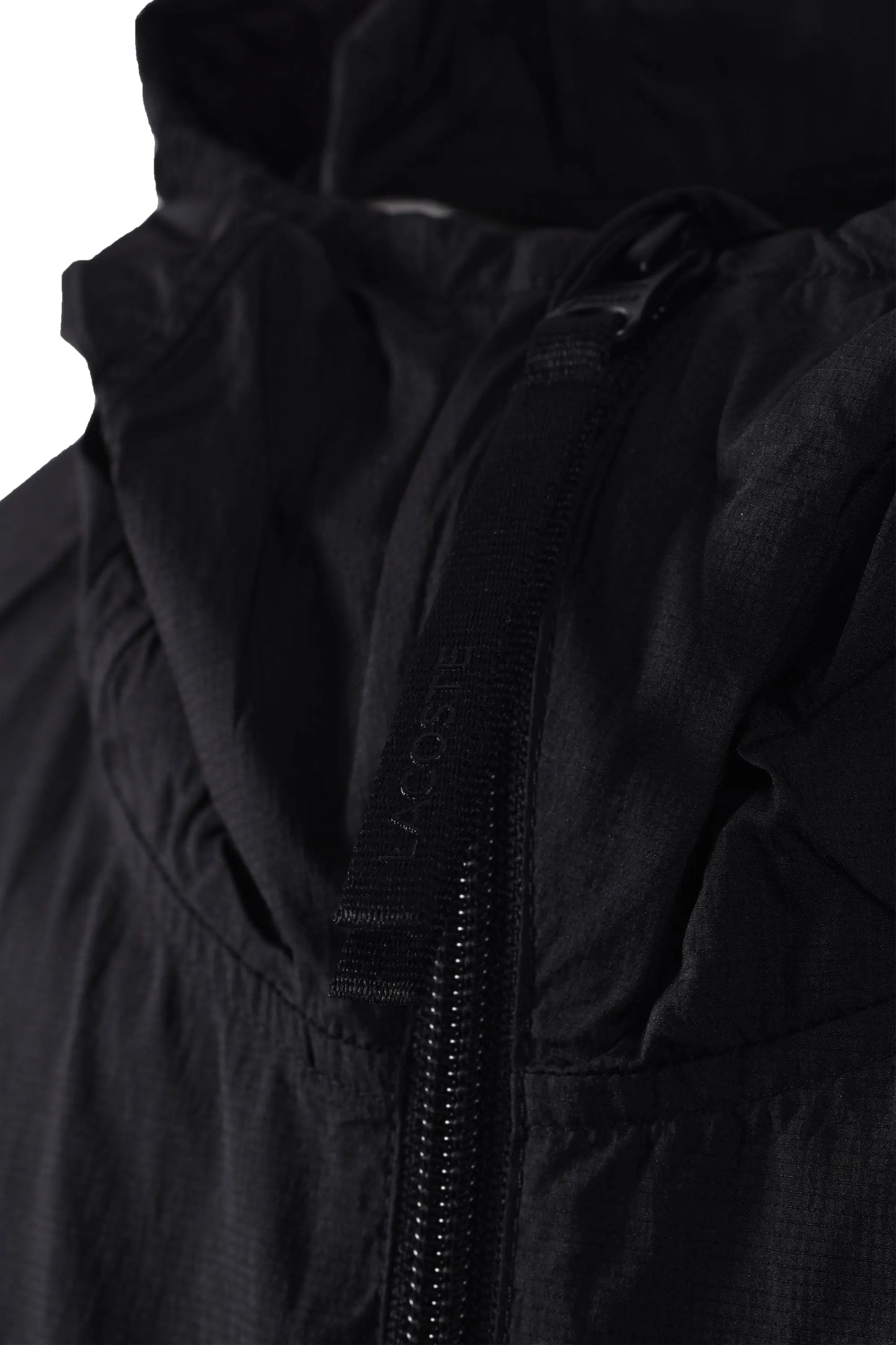 Close up of the branded Lacoste zipper on a lightweight jacket.