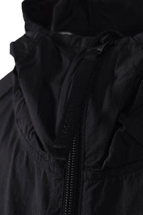 Close up of the branded Lacoste zipper on a lightweight jacket.