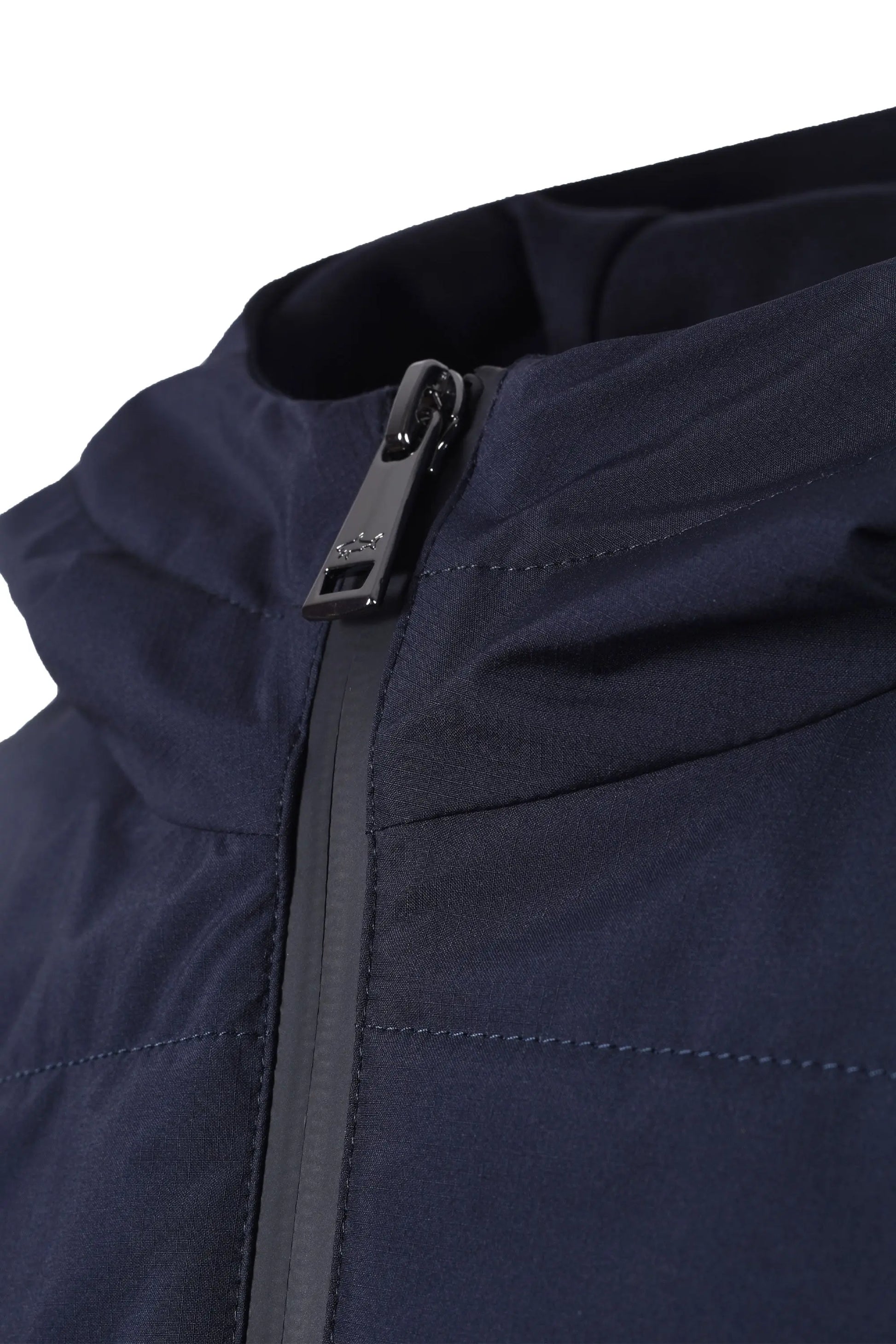 Close-up of a navy blue paul and shark jacket zipper on a white background