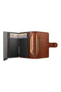 Brown SECRID wallet with open compartments on a white background