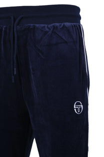Side picture of a pair of Sergio Tacchini trackpants made from a velour material, featuring white stripe detailing down the side of the trackpant as well as an embroidered Sergio Tacchini logo in white on the front of the garment.