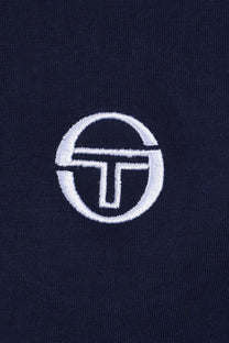 White sergio tacchini logo on a dark blue t-shirt 