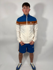 A man wearing a retro inspired track top in beige colour on a video