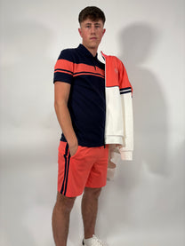 Man wearing a Sergio Tacchini t-shirt and shorts