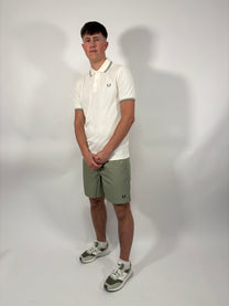 Man wearing a Fred Perry polo and shorts 
