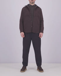 Man wearing a casual outfit an overshirt, knitwear and trousers